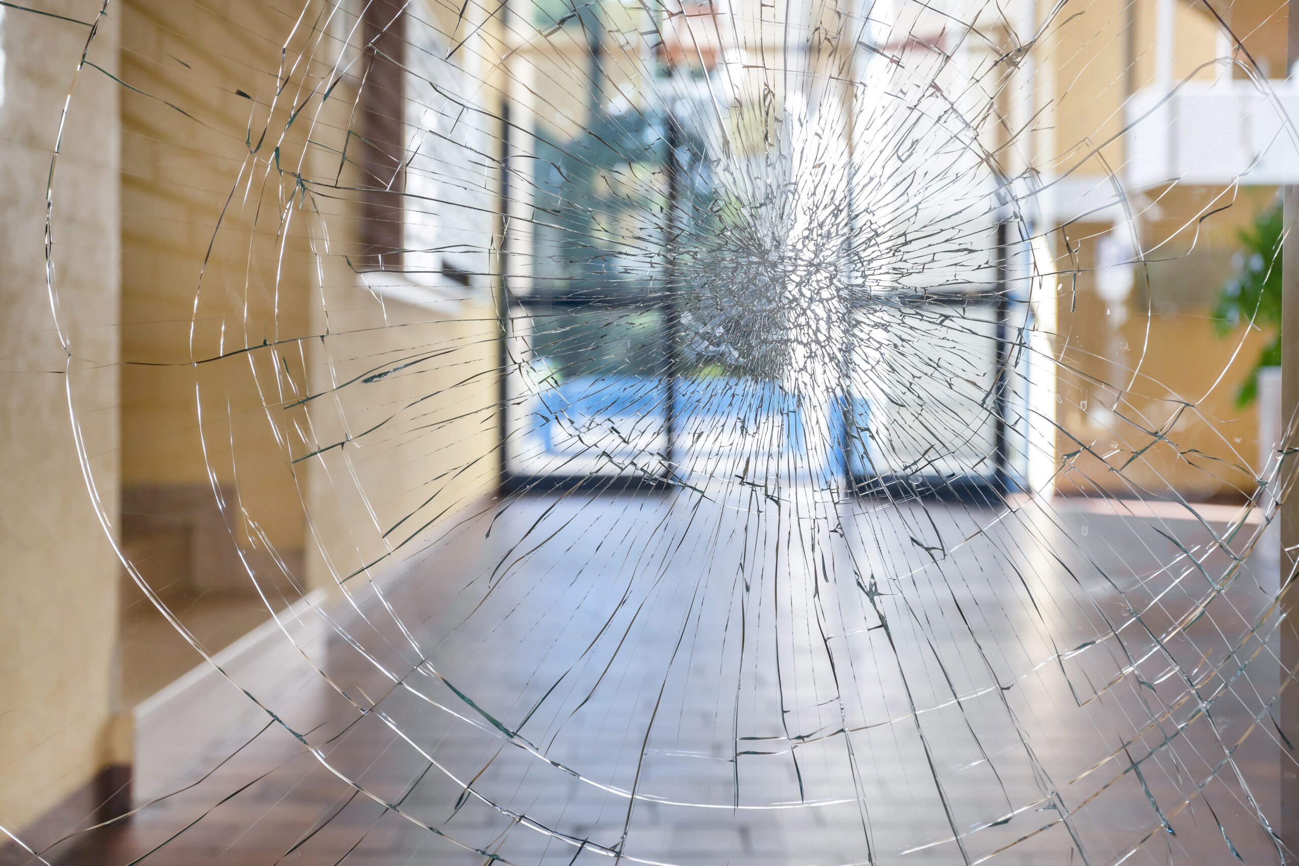 Shattered glass with security door in the back